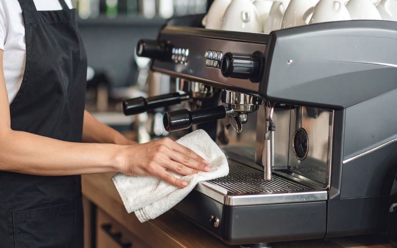 A collection of clean and sparkling coffee equipment, including a coffee maker, grinder, and French press.