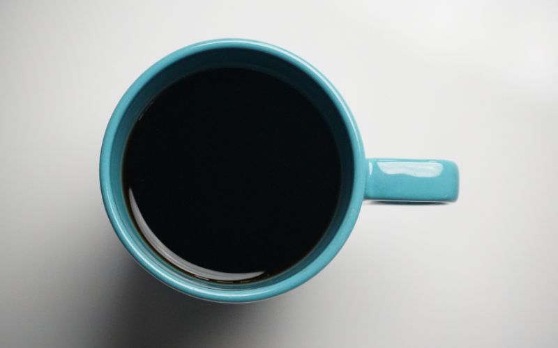 A mug of coffee, with a rich layer of crema on top, identifying it as an Americano.